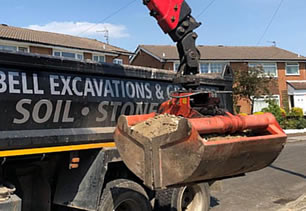 Crane removing dirt and rubble